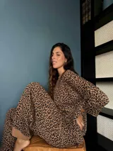 Conjunto de dos piezas tejido con estampado animal print, compuesto por un buzo de silueta oversize con cuello a la base y mangas 3/4, y un pantalón de corte holgado a juego.