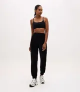 Pantalón tipo jogger de plush color negro, con cintura elástica, bolsillos laterales y puños ajustados en los tobillos.