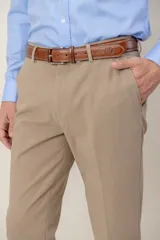 Pantalón de vestir corte slim fit, confeccionado en gabardina de lana color beige, con cierre frontal y bolsillos laterales.