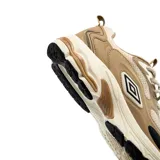 Championes Umbro Iren, color beige con detalles en negro y blanco, confeccionados con malla y revestimientos sintéticos, ideales para uso urbano.
