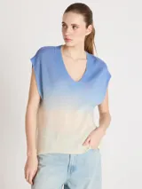 Chaleco de punto sin mangas con escote en V y diseño degradado que transiciona de azul a blanco, de silueta recta y hombros amplios con terminaciones acanaladas.