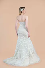 Vestido de novia corte sirena, color marfil, con escote corazón y bordados de tul con forro color nude.