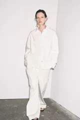 Sobrecamisa blanca de algodón con cuello solapa, manga larga y dos bolsillos de plastrón en el pecho. Cierre frontal con botones ocultos por solapa.