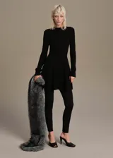 Vestido corto de punto acanalado con diseño peplum, cuello redondo y mangas largas. Presenta un ajuste entallado en el torso que se abre en la cintura con un corte evasé.