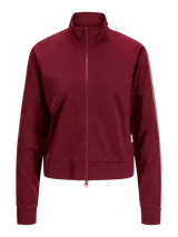 Campera deportiva de cuello alto y cierre frontal completo, confeccionada en tejido interlock color bordó. Presenta mangas largas con franjas laterales decorativas y puños elásticos.