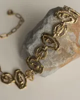 Gargantilla de diseño artesanal compuesta por eslabones de formas orgánicas y texturizadas, con cadena de ajuste posterior.