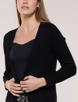 Cardigan abierto de punto acanalado marca Rio & Rian, color beige, con diseño de frente abierto sin botones y mangas largas.