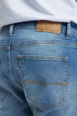 Pantalón de jean celeste, corte slim fit, con bolsillos delanteros y traseros.