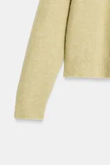 Jersey de punto de cuello redondo y manga larga, con textura jaspeada.