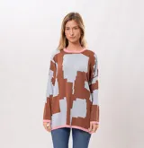 Buzo oversize de algodón con estampado geométrico en tonos marrones y celestes, con cuello y puños en color rosa.