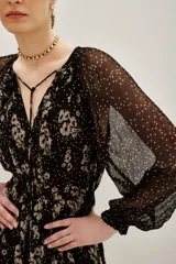 Vestido midi de viscosa con estampado floral y de lunares, cuello en V con lazo ajustable, mangas largas abullonadas con puños elásticos y falda fluida con forro interior.