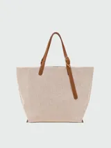 Bolso tote XL Longchamp modelo Complice, confeccionado en lona color crudo con detalles de cuero marrón en las asas y en un bolsillo frontal semicircular.