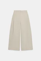 Pantalón de tiro medio con diseño de pierna ancha y corte recto. Presenta pinzas frontales, trabillas en la cintura, bolsillos laterales ocultos y cierre frontal con cremallera y ganchos metálicos.