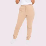 Pantalón tipo babucha de corte ajustado, color gris oscuro, con cintura elástica y cordón de ajuste. Presenta puños elásticos en los tobillos y bolsillos laterales.