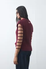 Chaleco tejido de punto color marrón, con diseño sin mangas, cuello redondo y textura acanalada vertical. Presenta terminaciones acanaladas en cuello, sisas y ruedo.