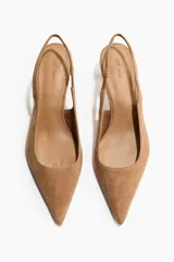 Zapatos destalonados de gamuza color tostado, con punta fina, tira elástica en el talón y taco kitten.