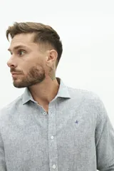 Camisa de manga larga de lino y algodón, color blanco con rayas verticales en tonos gris y beige. Presenta un corte semi slim y un pequeño logo bordado en el pecho.
