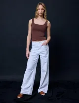 Jean de tiro alto con corte wide leg, color blanco. Presenta pretina con pasadores, cierre frontal con botón y bolsillos funcionales tanto en la parte delantera como en la trasera.