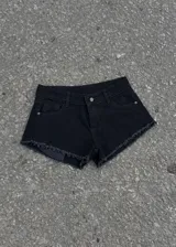 Short de jean negro de tiro bajo, con diseño clásico de cinco bolsillos, trabillas para cinto y bordes deshilachados.