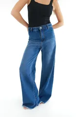 Pantalón de jean azul de corte ancho con terminación desflecada.