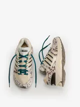 Championes Adidas Adistar Control 5 W, con diseño de running inspirado en los años 2000. Combinan tonos beige, marrones y detalles estampados tipo animal print con efecto de pelo, cordones verde oscuro y las icónicas tres tiras de la marca en los laterales.