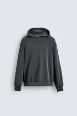 Sudadera tipo hoodie de corte relajado, confeccionada en tejido fluido con efecto lavado. Presenta cuello con capucha, mangas largas y terminaciones en rib.
