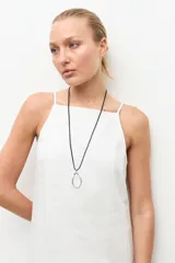 Vestido midi de lino color blanco, de corte recto y holgado, con escote cuadrado y tirantes finos.
