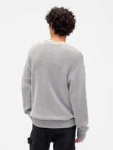 Buzo de tejido de punto acanalado con cuello redondo, mangas largas y puños ajustados.