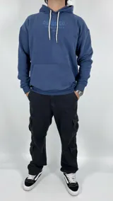 Canguro azul con capucha, corte oversize y estampado en el frente con la leyenda "Duxon Co." en letras mayúsculas, seguido de texto en japonés y la palabra "Tokyo".