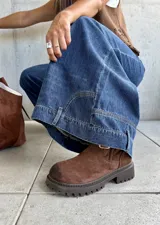 Jean de corte ancho y tiro medio, confeccionado en denim azul oscuro sin lycra. Presenta un diseño de pierna recta y holgada con costuras reforzadas.
