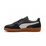 Championes Puma modelo Palermo LTH, de diseño clásico con base de cuero blanco, detalles en gamuza gris y la icónica franja lateral en negro. Presenta una suela de goma color caramelo y el logo de la marca en el lateral.