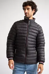 Campera puffer de nylon color azul marino, con cierre frontal completo, cuello alto y puños con detalle de rayas. Cuenta con bolsillos laterales con cierre y logo estampado en el pecho.