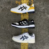 Championes Asics modelo EX89, de diseño retro inspirado en el básquetbol, con combinación de colores blanco y negro. Presentan una estructura de cuero con perforaciones en la puntera, cordones al tono y suela de goma resistente.