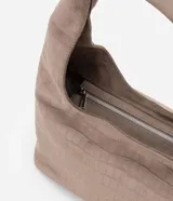 Cartera tipo hobo de tamaño grande, confeccionada en material sintético con textura de gamuza y grabado efecto crocco. Presenta una forma de media luna con cierre de cremallera y correa integrada para llevar al hombro.