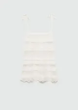Top de punto calado color crema con escote cuadrado, tirantes finos ajustables con lazo y terminaciones con diseño de encaje en el ruedo.