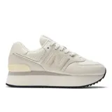 Championes New Balance modelo 574 para mujer, color blanco hueso o crema, con plataforma gruesa. Presenta capellada de gamuza y malla con el logo "N" superpuesto.