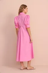 Vestido midi rosado con cuello camisero, mangas abullonadas con puños en contraste naranja y corte evasé.