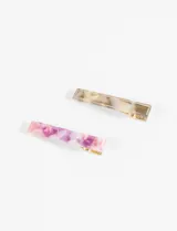 Set de dos clips rectangulares para el pelo, uno en tonos rosados y violetas con efecto marmolado, y otro en tonos beige y marrones con efecto carey.