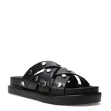 Sandalias slide de mujer Miss Carol modelo Nami, color negro con tiras cruzadas y tachas metálicas plateadas. Cuenta con suela plana con plataforma y diseño cómodo para uso diario.