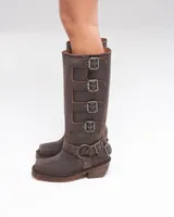 Botas altas de cuero marrón con acabado desgastado, múltiples hebillas metálicas laterales y tacón bajo cuadrado.