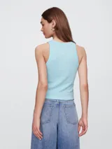 Musculosa de mujer color azul claro, de tejido acanalado, con cuello redondo y corte tipo nadador. Presenta el logo "GAP" estampado en el centro del pecho en un tono azul más claro.