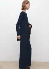Pantalón azul marino de tiro medio, corte ancho y recto, con pequeñas aberturas en los bajos.