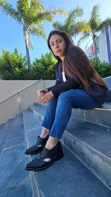 Zapatos de cuero negro con diseño destalonado y aberturas laterales, punta fina, taco cuadrado de 6 cm y costuras pespunteadas en el borde.