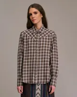 Camisa western a cuadros marrones, blancos y negros, con canesú y botones marrones.