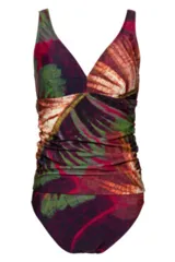 Tankini de una pieza con escote en V cruzado y frunces laterales para un efecto modelador. Estampado tropical con hojas en tonos rojizos, verdes, naranjas y morados.