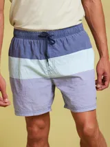 Short de baño con diseño de bloques de color en azul marino, celeste y lila. Tiene cintura elástica con cordón ajustable.