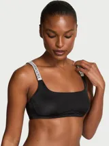 Bralette sin forro e inalámbrico de color negro, con escote cuadrado y tirantes ajustables brillantes con pedrería y monograma de la marca.