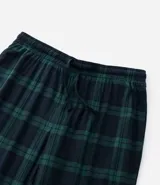 Pantalón de pijama de franela con estampa cuadrillé en tonos azul y verde. Tiene puños elásticos en los tobillos y cordón ajustable en la cintura.