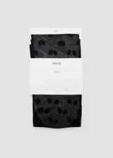 Medias de nylon transparentes color negro con estampado de lunares negros. Presentan una textura fina y elástica, ideales para complementar looks formales o de fiesta.