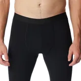 Calza térmica deportiva de hombre Columbia modelo Midweight Stretch, color negro, con diseño ajustado y tecnología Omni-Heat reflectante para retener el calor corporal y Omni-Wick para control de humedad.